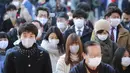Orang-orang yang memakai masker wajah melakukan tradisi doa untuk Tahun Baru pada hari kerja pertama tahun ini di Kuil Kanda Myojin, di Tokyo, Jepang, Senin (4/1/2021).  Masyarakat Jepang berdoa bersama di kuil tersebut untuk memohon kelancaran bisnis. (AP Photo/Koji Sasahara)