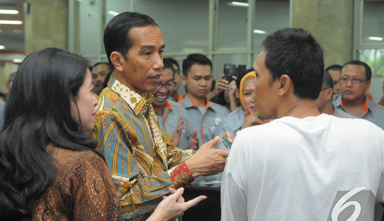 Presiden Jokowi berdialog dengan seorang warga yang mengantre untuk mendapatkan Kartu Indonesia Sehat di Kantor Pos Pasar Baru, Jakarta, Senin (3/11/2014). (Liputan6.com/Herman Zakharia)
