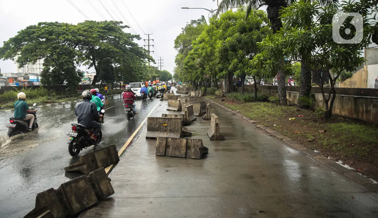 Kondisi separator busway yang berserakan pascabanjir di Jalan Daan Mogot, Cengkareng, Jakarta, Jumat (3/1/2020). Separator busway tersebut berantakan akibat banjir yang menerjang sejak kemarin. (Liputan6.com/Faizal Fanani)