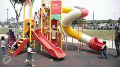 Sejumlah anak bermain di areal RPTRA Kalijodo, Jakarta, Jumat (14/4). Sejumlah warga menghabiskan libur Paskah dengan mengajak putra-putrinya bermain di areal RPTRA Kalijodo. (Liputan6.com/Faizal Fanani)