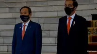 Meski diguyur hujan Presiden RI Joko Widodo tetap menyambut kehadiran PM Jepang Suga Yoshihide (Sekretariat Kepresidenan)