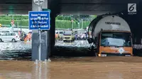 Truk berusaha melintasi banjir di terowongan Dukuh Atas, Jakarta, Senin (11/12). Hujan lebat yang mengguyur ibu kota mengakibatkan genangan hingga satu meter di lokasi tersebut. (Liputan6.com/Faizal Fanani)