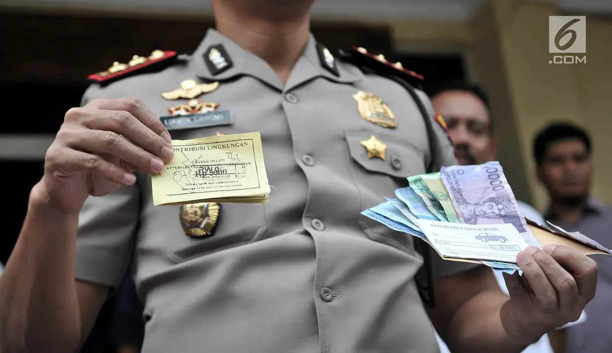 Kapolsek Metro Tanah Abang AKBP Lukman Cahyono menunjukkan barang bukti saat rilis kasus retribusi dan parkir liar di Mapolsek Tanah Abang, Jakarta, Senin (4/6). Para tersangka beraksi di wilayah Thamrin City. (Merdeka.com/Iqbal S Nugroho)