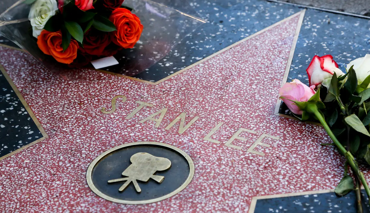 Penggemar meletakkan memorabilia di atas bintang Walk of Fame milik Stan Lee di California, Senin (12/11). Stan Lee, kreator Captain America dan beberapa tokoh superhero Marvel lainnya, meninggal dunia di usia 95 tahun. (Gabriel Olsen/Getty Images/AFP)