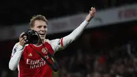 Pemain Arsenal, Martin Odegaard mengarahkan pose saat merayakan kemenangan setelah laga lanjutan Liga Inggris 2023/2024 melawan Liverpool di Emirates Stadium, London, Inggris, Minggu (05/02/2024) WIB. (AFP/Ian Kington)