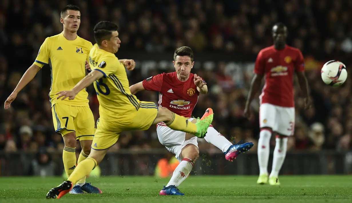 Gelandang Manchester United, Ander Herrera mengumpan bola dari kawalan dua pemain Rostov pada babak 16 Liga Europa di Stadion Old Trafford, Inggris (16/3). MU menang atas Rostov dengan skor 1-0 agregat (2-1). (AFP Photo/Oli Scarff)