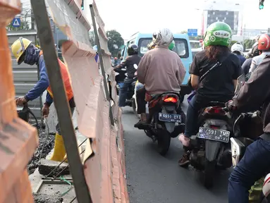 Aktivitas pekerja menyelesaikan proyek revitalisasi trotoar di Jalan Salemba Raya, Jakarta, Jumat (6/9/2019). Proyek revitalisasi trotoar dengan anggaran Rp 75 miliar ini ditargetkan rampung pada Desember mendatang. (Liputan6.com/Helmi Fithriansyah)