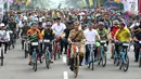 Presiden Joko Widodo atau Jokowi (tengah) didampingi Gubernur Jawa Barat Ridwan Kamil (kanan) saat mengikuti Bandung Lautan Sepeda, Sabtu (10/11). Jokowi menaiki sepeda ontel dalam kegiatan tersebut. (Liputan6.com/Angga Yuniar)