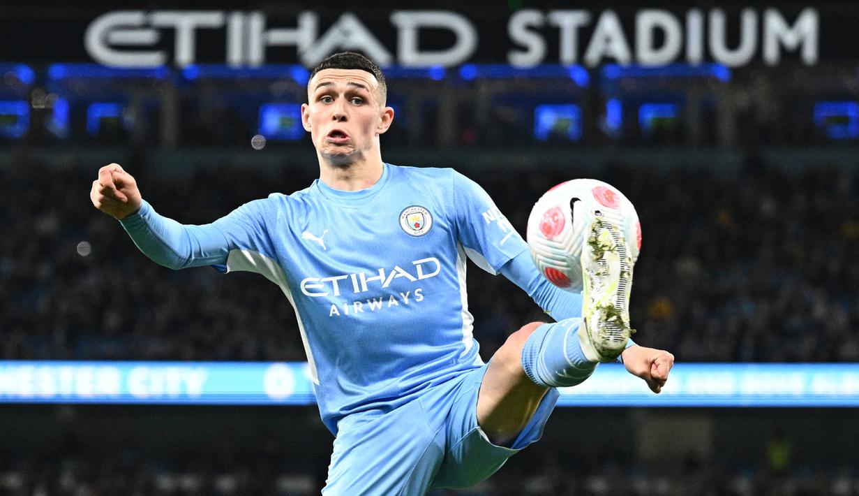 Phil Foden. Gelandang Inggris berusia 21 tahun yang memperkuat Manchester City sejak awal musim 2017/2018 usai dipromosikan dari tim U-18 ini mampu mencetak 9 gol dan 5 assist dari 28 laga di Liga Inggris selama musim 2021/2022. Berkat raihan tersebut dan performa apiknya di lini tengah, The Citizens dibawanya menjuarai Liga Inggris musim ini. Ia pun berhasil meraih gelar keduanya secara berturut-turut sebagai pemain muda terbaik Liga Inggris musim 2021/2022. (AFP/Oli Scarff)