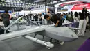 Seorang pria melihat model drone VTOL sayap tetap M12 di stan Micro Multi Copter (MMC) selama Drone World Congress (DWC) di Shenzhen pada 21 Mei 2026. (HECTOR RETAMAL/AFP)
