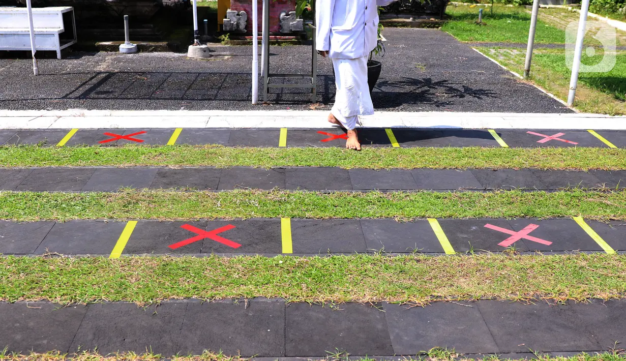 Penanda jaga jarak fisik atau physical distancing terpasang di Pura Kerta Jaya, Kota Tangerang, Banten, Rabu (3/6/2020). Pura Kerta Jaya menerapkan pemberlakuan protokol kesehatan selama masa pandemi virus corona COVID-19 seiring rencana kembali dibukanya tempat ibadah. (Liputan6.com/Angga Yuniar)