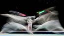 Atlet Anggar asal Italia Luca Curatoli (kiri) bertanding melawan Iulian Teodosiu dari Rumania dalam kualifikasi men's sabre individual  Olimpiade Tokyo 2020 di Makuhari Messe Hall, Prefektur Chiba, Jepang, Sabtu (24/7/2021). (Foto: AFP/Mohd Rasfan)