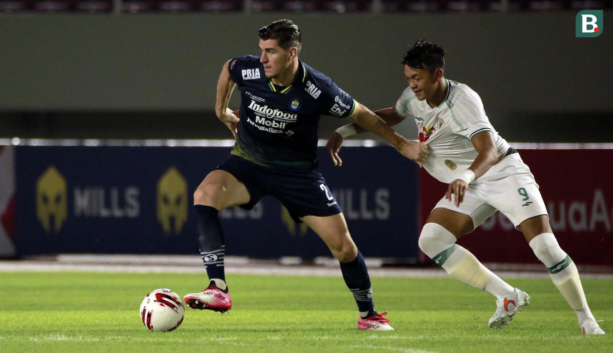 Pemain Persib Bandung, Nick Kuipers (kiri) menguasai bola dibayangi pemain PS Sleman, Saddam Emiruddin Gaffar dalam laga leg kedua semifinal Piala Menpora 2021 di Stadion Manahan, Solo, Senin (19/4/2021). Persib bermain imbang 1-1 dengan PS Sleman. (Bola.com/Ikhwan Yanuar)