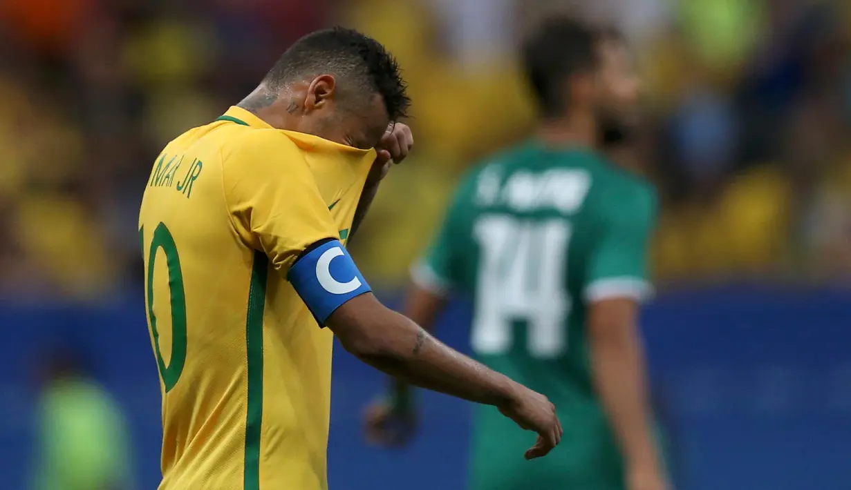 Penyerang Brasil, Neymar menutup mukanya dengan Jersey usai pertandingan melawan Irak di cabang olahraga sepakbola putra Olimpiade Rio de Janeiro 2016 di Stadion Mane Garrincha, Senin (8/8). Irak menahan imbang Brasil 0-0. (REUTERS/Ueslei Marcelino)