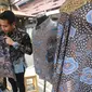 Peserta pameran merapikan baju batik khas Trenggalek di Pasar Lestari, Bentara Budaya, Jakarta (19/05/2023). Pasar Lestari merupakan bagian akhir dari program Indeks Daya Saing Daerah Berkelanjutan (IDSDB) periode 2021-2023, yang secara garis besar berupaya mendorong implementasi pembangunan berkelanjutan oleh pemerintah daerah di tingkat kabupaten. (Liputan6.com)