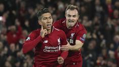 Striker Liverpool, Roberto Firmino, melakukan selebrasi bersama Xherdan Shaqiri usai membobol gawang Crvena Zvezda pada laga Liga Champions, di Stadion Anfield, Rabu (24/10/2018). Liverpool menang 4-0 atas Crvena Zvezda. (AP/Jon Super)