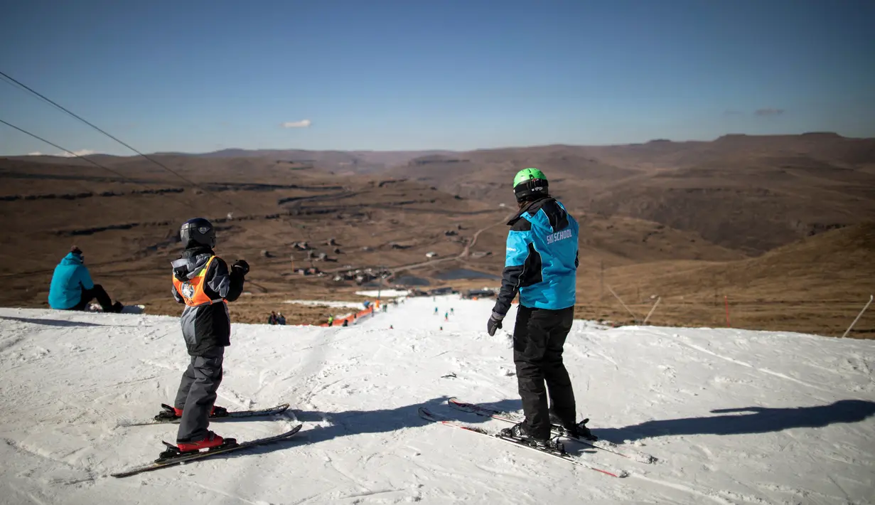 Seorang instruktur ski mengajar pemain pemula di resor ski Afriski, Pegunungan Maluti, Kerajaan Lesotho, Rabu (11/7). Lesotho merupakan satu-satunya negara merdeka yang seluruh bagiannya terletak di atas ketinggian 1.000 meter. (Marco Longari/AFP)
