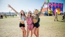 Tiga wanita bergembira saat menghadiri Coachella Music & Arts Festival di Empire Polo Club di Indio, California (15/4). Festival Coachella ini sudah ada sejak 1999. (Photo by Amy Harris/Invision/AP)