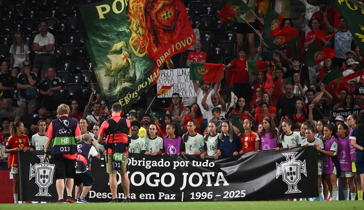 Diogo Jota meninggal dunia bersama adiknya, Andre Silva dalam sebuah kecelakaan di kilometer 65 A-52, dekat wilayah Zamora, Sanabria, Spanyol pada Rabu (3/7/2025) sekitar pukul 00.30 waktu setempat. Tampak dalam foto, para pemain timnas Portugal berdiri di belakang spanduk untuk memberikan penghormatan kepada penyerang Liverpool asal Portugal, Diogo Jota, pada akhir pertandingan sepak bola UEFA Women's Euro 2025 Grup B melawan Spanyol dan Portugal di stadion Wankdorf, Bern, Jerman pada tanggal 3 Juli 2025. (SEBASTIEN BOZON/AFP)