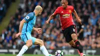 Striker Manchester United Anthony Martial (kanan) mencoba melewati hadangan bek Manchester City Pablo Zabaleta pada laga Premier League di Stadion Etihad, Manchester, Kamis (27/4/2017). (AFP/Paul Ellis)