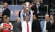 Pelatih Arsenal, Arsene Wenger, mengangkat trofi usai menjuarai final Piala FA melawan Chelsea di Stadion Wembley, Sabtu (27/5/2017). Arsenal menang 2-1. (AP/Matt Dunham)