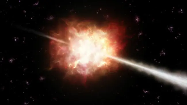 Ilustrasi semburan sinar gamma (gamma-ray burst, GRB) dari suatu supernova yang sedang akan mati. (Sumber Wikimedia Commons)