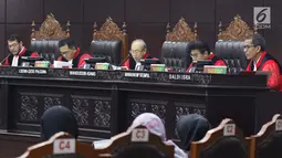 Hakim Mahkamah Konstitusi, Wahiduddin Adams (tengah) membacakan nota putusan perkara pengujian undang-undang tentang ASN, Sistem Pendidikan Nasional, Pendidikan dan Gelar Profesi, di Gedung MK, Jakarta, Kamis (14/2). (Liputan6.com/Helmi Fithriansyah)