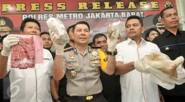 Kapolres Jakarta Barat, Kombes Roycke Langie menunjukan barang bukti hasil pengungkapan kasus narkotika di Jakarta, Senin (30/1). Petugas menyita barang bukti sabu 7,2 kg, tembakau gorilla 1,8kg dan 600 butir happy five. (Liputan6.com/Yoppy Renato)