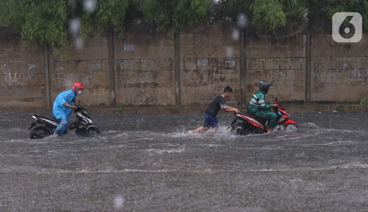 Pengendara terjebak banjir yang menggenangi jalan Bayangkara Pusdiklat, Kota Tangerang Selatan, Banten, Selasa (2/11/2021). BMKG mengeluarkan peringatan potensi cuaca ekstrem di wilayah Jakarta, Bogor, Depok, Tangerang, dan Bekasi (Jabodetabek). (Liputan6.com/Angga Yuniar)