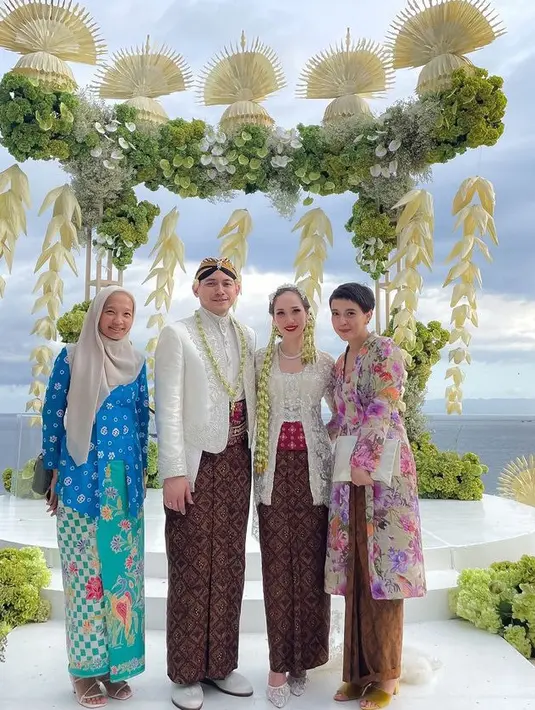 Fikha Effendi mengenakan kebaya panjang dengan motif bunga yang dipadukan kain lilit batiknya. [@ficzze]