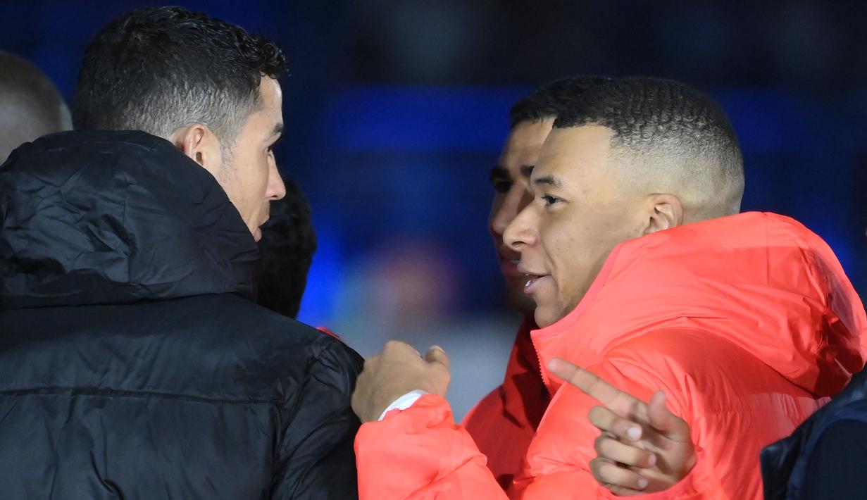 Pemain PSG, Kylian Mbappe (kiri) berbincang dengan Cristiano Ronaldo setelah laga Riyadh Season Cup antara Riyadh All-Star melawan PSG yang berlangsung di King Fahd Stadium, Riyadh, Jumat (20/1/2023) dini hari WIB. Pertemuan keduanya dimanfaatkan oleh Kylian Mbappe yang menjadikan Cristiano Ronaldo sebagai panutannya di dunia sepak bola sejak dirinya masih kecil. (AFP/Franck Fife)
