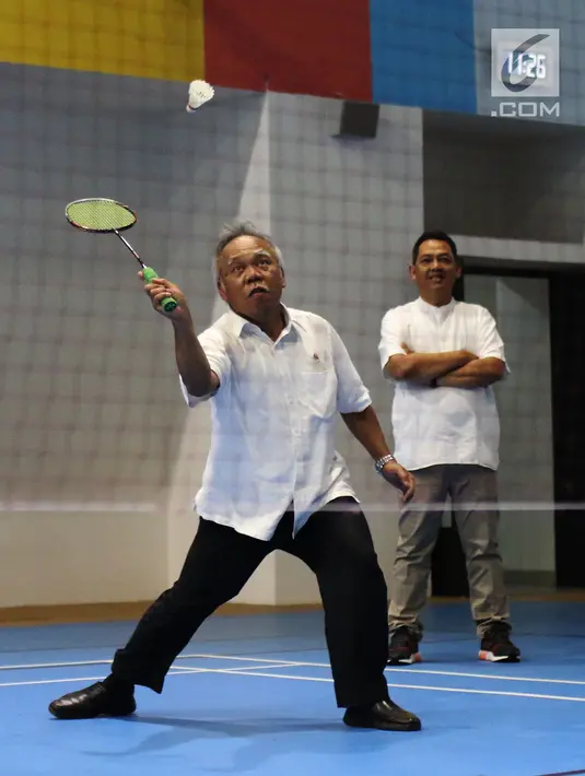 Menteri PUPR, Basuki Hadimuljono mengembalikan kok saat bertanding bulu tangkis disela kunjungannya di Training Facility Gelora Bung Karno Jakarta, Kamis (10/5). Basuki meninjau kesiapan fasilitas dan prasarana Asian Games 2018 (Liputan6.com/Angga Yuniar)