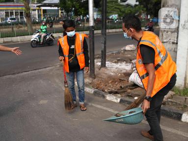 Petugas Satpol PP mengawasi pelanggar saat razia masker di depan Stasiun Klender, Jakarta, Selasa (10/5/2022). Pemerintah memastikan akan terus memperpanjang masa pemberlakuan pembatasan kegiatan masyarakat (PPKM) se-Indonesia hingga waktu yang belum ditentukan. (Liputan6.com/Faizal Fanani)