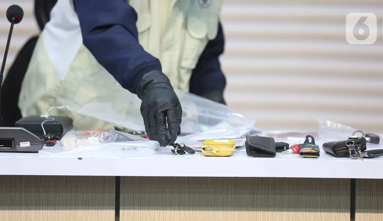 Petugas memperlihatkan barang bukti Operasi Tangkap Tangan (OTT) di Kantor Imigrasi Jakarta Barat, Gedung Merah Putih KPK, Jakarta, Kamis (4/6/2026). (Liputan6.com/Helmi Fithriansyah)