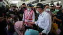 <p>Menko PMK Muhadjir Effendy (kanan) dan Menteri Perhubungan Budi Karya Sumadi membagikan masker kepada calon penumpang saat melepas Mudik Aman Mudik Sehat di Terminal Jatijajar, Depok, Jawa Barat, Kamis (28/4/2022). Enesis Group membuka posko mudik dan arus balik di beberapa titik di Pulau Jawa sejak 25 April hingga 8 Mei 2022 untuk memberikan kenyamanan dan keamanan bagi masyarakat. (Liputan6.com/Faizal Fanani)</p>