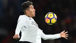 Gelandang Liverpool, Roberto Firmino mengendalikan bola selama pekan 18 Premier League ketika bertandang ke markas AFC Bournemouth di Vitality Stadium, Minggu (17/12). Liverpool mencukur tuan rumah AFC Bournemouth empat gol tanpa balas. (GLYN KIRK / AFP)
