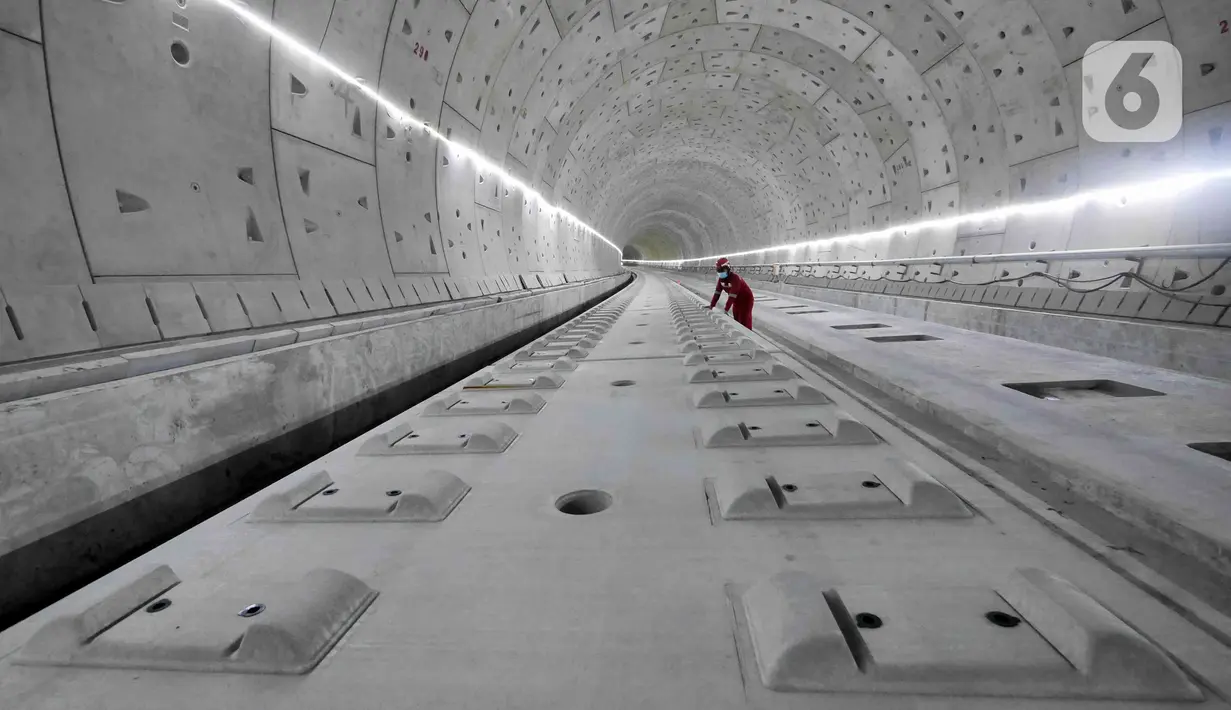 Pekerja menyelesaikan pengerjaan proyek Tunnel 1 Halim Kereta Cepat Jakarta-Bandung di Jalan Tol Jakarta-Cikampek KM 5+500, Jakarta, Kamis (27/1/2022). Tunnel 1 merupakan terowongan dua lintasan kereta cepat yang menembus bagian bawah Jalan Tol Jakarta-Cikampek. (Liputan6.com/Herman Zakharia)