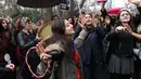 Seorang wanita bernyanyi dan menari saat berkumpul untuk memperingati Women's Day atau Hari Perempuan Internasional di Ankara, Turki, Kamis (8/3). (ADEM ALTAN/AFP)