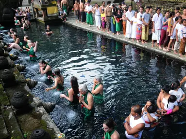 Wisatawan antri membersihkan diri (melukat) di Pura Tirta Empul, Desa Tampaksiring, Gianyar, Bali, jumat (6/5/20222). Dalam sehari, lebih dari 2.000 wisatawan berkunjung ke obyek wisata spiritual i yang menjadi salah satu primadona di Pulau Bali ini. (merdeka.com/Arie Basuki)