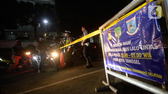 Polisi dibantu Satpol PP dan Dishub mengatur lalu lintas pengalihan arus di depan RS Sari Asih, Tangerang Selatan, Banten, Sabtu (9/5/2020). Pengalihan arus dalam rangka pelaksanaan PSBB untuk memutus penularan Covid-19 di wilayah Tangsel mulai jam 22.00 hingga 05.00. (merdeka.com/Dwi Narwoko)