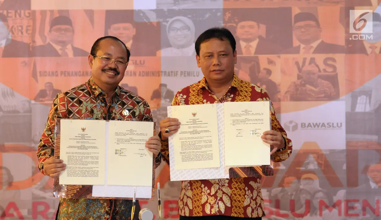 Ketua Bawaslu, Abhan (kanan) bersama Ketua Ombudsman RI Amzulian Rifai menunjukkan nota kesepahaman atau Mou pada perayaan HUT 1 Dasawarsa Bawaslu di Jakarta, Senin (9/4). (Liputan6.com/Helmi Fithriansyah)