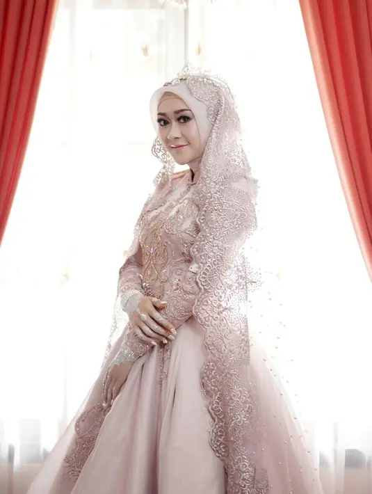 Gaunpenganti berwarna pink yang megah dan elegan sangat cocok dikenakan oleh Ellen. Riasan di wajahnya pun juga cantik, seperti para pengantin wanita pada umumnya.  (Instagram/ellennitaa)