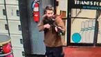 Dalam gambar yang diambil dari video yang dirilis oleh Kantor Sheriff Androscoggin County, seorang pria bersenjata tak dikenal menodongkan pistol saat memasuki Sparetime Recreation di Lewiston, Maine, Amerika Serikat, Rabu (25/10/2023). Polisi Negara Bagian Maine memerintahkan penduduk di kota terbesar kedua di negara bagian itu untuk berlindung di tempat karena tersangka masih buron. (Androscoggin County Sheriff's Office via AP)