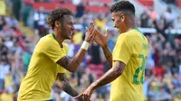 Striker Brasil, Neymar, merayakan gol yang dicetak Roberto Firmino ke gawang Kroasia pada laga persahabatan di Stadion Anfield, Liverpool, Minggu (3/6/2018). Brasil menang 2-0 atas Kroasia. (AFP/Oli Scarff)