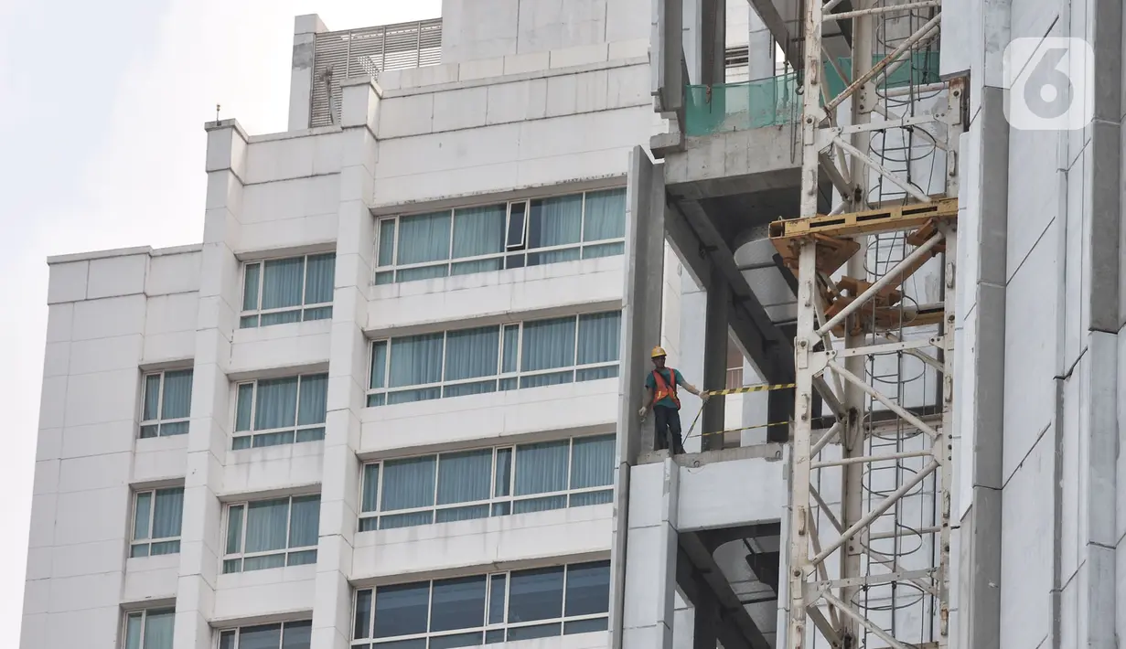 Pekerja menyelesaikan pembangunan gedung tingkat di kawasan Jalan Jenderal Sudirman, Jakarta, Selasa (21/1/2020). Kementerian Koordinator Bidang Perekonomian akan mengatur upah minimum pekerja dan rencana skema upah per jam dalam Draf RUU Omnibus Law Cipta Lapangan Kerja. (merdeka.com/Iqbal Nugroho)
