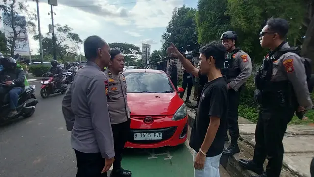 Anggota kepolisian mendatangi korban yang sempat dianiaya kelompok mata elang di Jalan Raya Juanda depan Gema Insani, Sukmajaya, Depok.