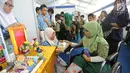 Seorang murid SD berkursi roda mendapatkan penjelasan cara kerja dinamo mekanik yang dapat menimbulkan listrik dari murid SMPN 3 Tangsel saat kegiatan PIF 2018 di kawasan Puspiptek, Setu, Tangerang Selatan, kamis (27/9). (Merdeka.com/Arie Basuki)