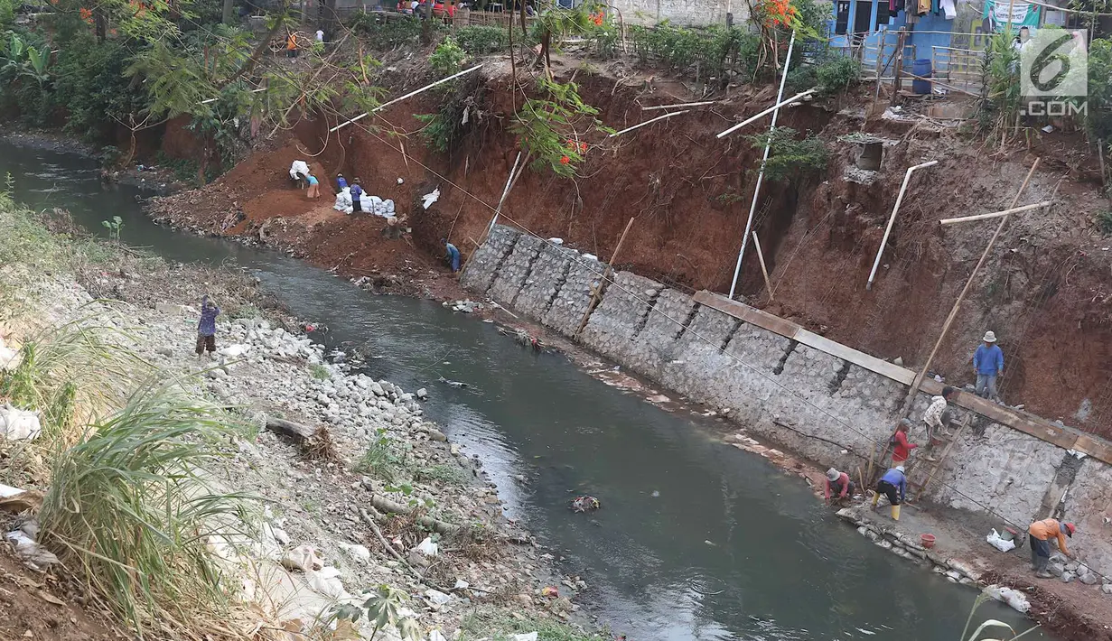 Pekerja membangun turap di bantaran Kali Cijantung, Jakarta Timur, Kamis (11/10). Pembangunan turap bertujuan mencegah longsor yang dapat membahayakan warga sekitar. (Liputan6.com/Immanuel Antonius)