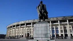 Patung pendiri Soviet Vladimir Lenin terlihat di depan Luzhniki Stadium, Moskow, Senin (23/4). Stadion yang dibangun sejak 1956 ini akan menjadi lokasi upacara pembukaan dan penutupan piala dunia 2018. (AP Photo/Pavel Golovkin)