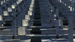 Kuburan dengan potrait tentara yang tewas dalam invasi Turki ke Siprus terlihat di pemakaman militer Tymvos Macedonitissas, Nicosia, Siprus, Senin (20/7/2020). Ribuan orang Yunani dan tentara Siprus tewas selama invasi Turki ke Pulau Siprus pada tahun 1974. (AP Photo/Petros Karadjias)